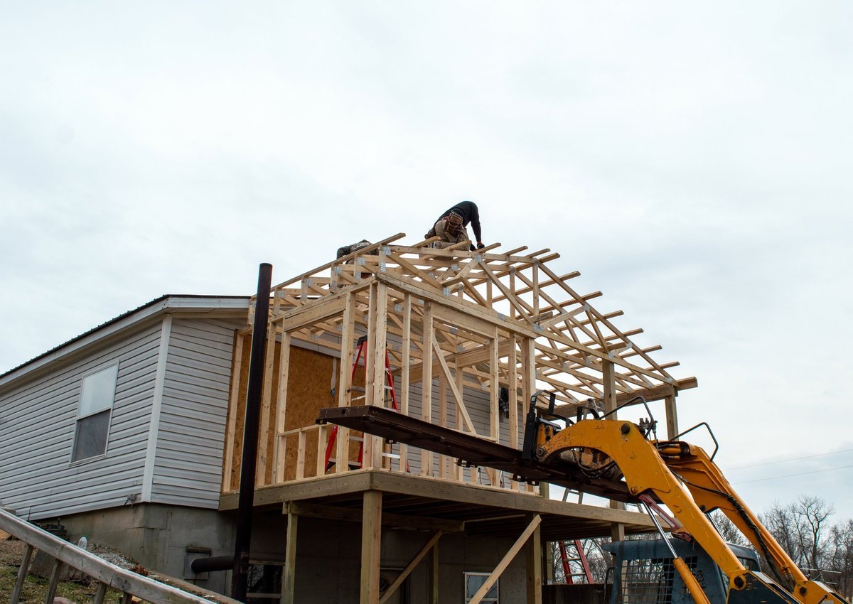 Carpenters working on a new house roof structure