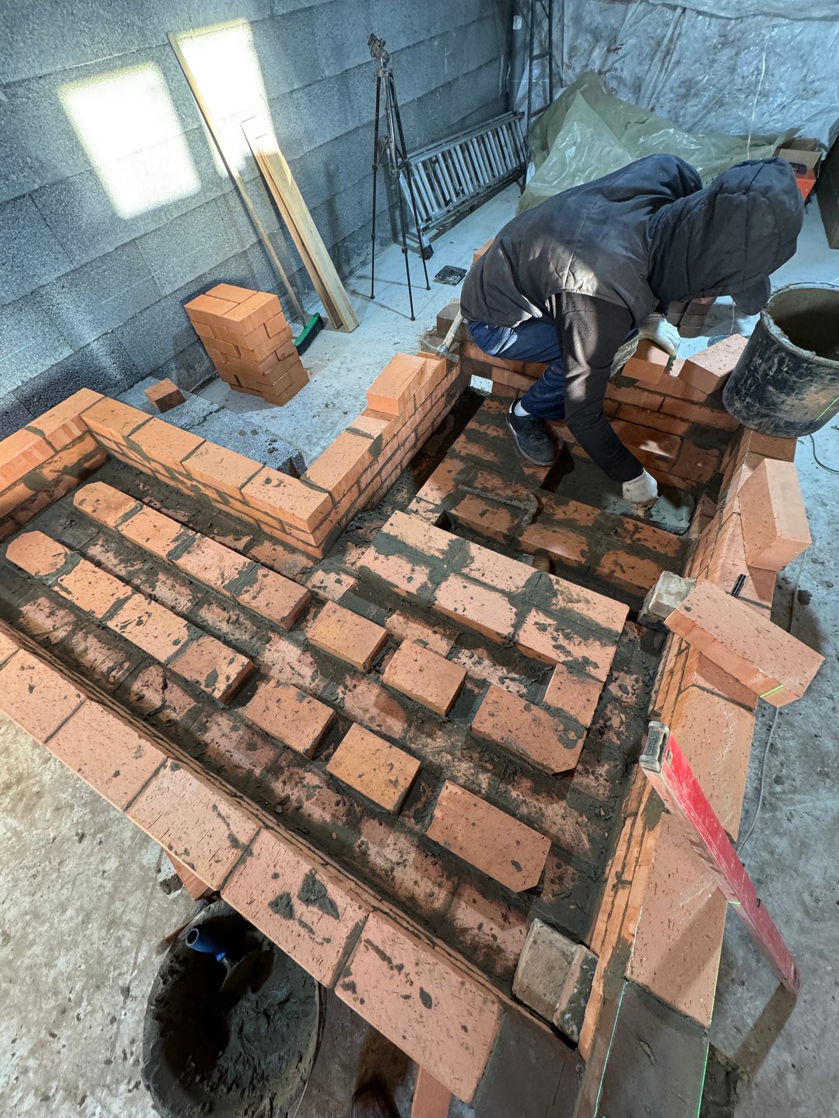 Fresh brickwork and mortar on a stove bench showing neat pointing
